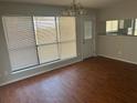 Dining area with wood floors, chandelier lighting, and sliding glass door at 503 N Shore Rd, Lithonia, GA 30058