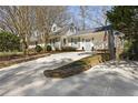 Inviting two-story home with an extended driveway, featuring a freshly painted exterior and lovely landscaping at 2553 Ridgewood Nw Ter, Atlanta, GA 30318