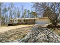 One-story home with brick and siding, attached garage, and a long driveway at 4205 S Hurt Sw Rd, Smyrna, GA 30082