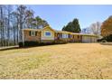Inviting single-story home with brick accents, well-maintained lawn, and a convenient attached garage at 4205 S Hurt Sw Rd, Smyrna, GA 30082