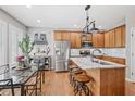 Bright kitchen featuring an island with seating, stainless steel appliances, and hardwood floors at 4364 Grove Field Ct, Suwanee, GA 30024