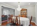 Formal dining room with a wooden table, chairs, chandelier, and view to living room at 603 Dunbar Dr, Dunwoody, GA 30338