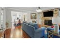 Open-concept living space with living room, dining room and stone fireplace at 603 Dunbar Dr, Dunwoody, GA 30338