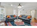 Bright living room featuring two couches, hardwood floors, and an elegant chandelier at 603 Dunbar Dr, Dunwoody, GA 30338