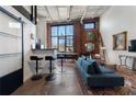 Cozy living room featuring exposed brick, tall windows, and modern decor at 174 Chester Se Ave # 127, Atlanta, GA 30316