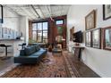 Open-concept living room with exposed brick, high ceilings, and stylish furnishings at 174 Chester Se Ave # 127, Atlanta, GA 30316