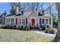 Inviting home with dormer windows, a chimney, and red shutters, complemented by a green lawn at 2953 Hardman Ne Ct, Atlanta, GA 30305