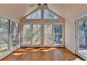 Sun room featuring hardwood floors, cathedral ceilings, and large windows for ample natural light at 2953 Hardman Ne Ct, Atlanta, GA 30305