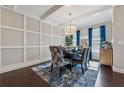 Beautiful dining room features hardwood floors, modern lighting, wainscoting and large windows at 4727 Tiger Blvd, Duluth, GA 30096