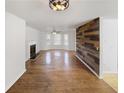Open living room features hardwood floors, fireplace, and unique wood accent wall at 4152 Coconut Nw Grv, Acworth, GA 30101