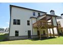 Back of the house with a deck and backyard grass at 480 Brown Dove Ln, Grayson, GA 30017