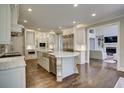 Bright and spacious kitchen with marble island, stainless steel appliances, and custom cabinetry at 11020 Bradford Ln, Suwanee, GA 30024