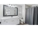 Bathroom featuring a shower, modern vanity with updated fixtures, and tiled floors at 266 Carthage Blvd, Rockmart, GA 30153