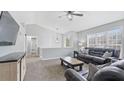 Bright living room with vaulted ceilings, a ceiling fan, and large windows at 266 Carthage Blvd, Rockmart, GA 30153