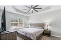 Cozy bedroom featuring neutral paint, tray ceilings, ceiling fan, and ample natural light at 266 Carthage Blvd, Rockmart, GA 30153