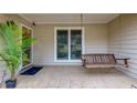 Inviting front porch with tile flooring, hanging swing, perfect for relaxing and enjoying the outdoors at 106 Lanyard Bnd, Peachtree City, GA 30269
