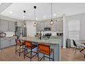 Modern kitchen featuring a large island, stainless steel appliances, and stylish pendant lighting at 108 Rex Ave, Canton, GA 30114
