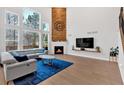 Bright living room with soaring ceilings, a cozy fireplace, and large windows offering scenic views at 108 Rex Ave, Canton, GA 30114
