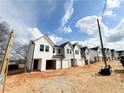 Street view of new construction homes with modern facades and individual garages at 11598 E Lovejoy Rd, Hampton, GA 30228