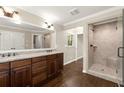 Bathroom with double vanity, large mirror, and frameless glass shower, offering a clean and modern design at 541 Hickory Sw Dr, Marietta, GA 30064