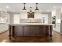 Spacious kitchen featuring a large dark wood island, white cabinets, stainless steel appliances, and pendant lighting at 541 Hickory Sw Dr, Marietta, GA 30064