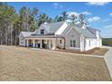 Beautiful single-Gathering home with a covered front porch, a sprawling lawn, and a side-entry garage at 847 Cumberland Ave, Dallas, GA 30157