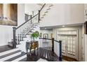 Bright entryway with hardwood floors, staircase with white railings, and decorative chest at 1377 Village Park Ne Dr, Brookhaven, GA 30319