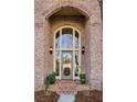 Elegant front door with brick surround, transom window, and decorative wreath at 1377 Village Park Ne Dr, Brookhaven, GA 30319