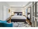 Cozy main bedroom featuring a king bed, large mirror, and hardwood floors at 1377 Village Park Ne Dr, Brookhaven, GA 30319