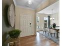 Bright entryway showcasing hardwood floors, a decorative wall hanging, and a glimpse into the dining room at 280 Rockledge Sw Bnd, Powder Springs, GA 30127