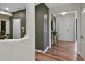 Hallway with hardwood floors and neutral walls, leading to various rooms within the home at 280 Rockledge Sw Bnd, Powder Springs, GA 30127