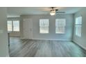 Bright living room with large windows and wood-look flooring, creating a welcoming space at 425 Camella Cir, Mcdonough, GA 30252