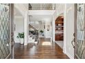 Grand foyer with dark hardwood floors, staircase and access to the home's interior at 4865 Meadow Park Ln, Suwanee, GA 30024