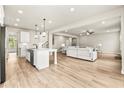 Open-concept living space with hardwood floors seamlessly connects the kitchen and living room at 3114 Thicket Ln, Atlanta, GA 30349