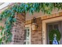 Close-up of a home's entrance with a wreath, lanterns, and brick detailing at 219 Dawson Dr, Woodstock, GA 30188