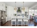 Bright kitchen with gray cabinets, white countertops, and stainless steel appliances at 219 Dawson Dr, Woodstock, GA 30188