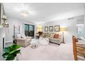 Bright living room featuring neutral walls, plush seating, and a sliding door to the balcony at 2707 Cumberland Se Ct, Smyrna, GA 30080