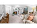 Cozy living room with fireplace, mantle mirror, and access to a balcony at 2707 Cumberland Se Ct, Smyrna, GA 30080