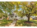 Beautiful home with a large tree, a brick walkway and healthy green grass at 1471 Hardin Ave, College Park, GA 30337