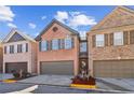 Charming brick townhome featuring a two-car garage and well-maintained landscaping at 1921 Harrison Park Dr, Atlanta, GA 30341