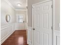 Inviting hallway featuring hardwood floors and classic white wainscoting at 1921 Harrison Park Dr, Atlanta, GA 30341