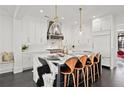 Gourmet kitchen features an island with waterfall countertops, pendant lights, and modern appliances at 255 Marjean Way, Alpharetta, GA 30009