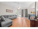 Cozy living room with a ceiling fan, fireplace, and a comfortable gray sofa at 840 Cline Petty Way Way, Lawrenceville, GA 30043