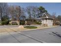 Community entrance with a sign and guard house, offering a secure and welcoming environment at 1932 Variations Ne Dr, Atlanta, GA 30329