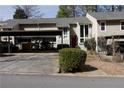 Charming home exterior with well-maintained landscaping and a convenient carport at 1932 Variations Ne Dr, Atlanta, GA 30329