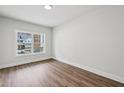 Empty bedroom with a large window and wood-look flooring at 3128 Stonegate Sw Dr, Atlanta, GA 30331