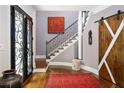 Elegant foyer features decorative glass front doors, hardwood floors, and staircase with iron railing at 1165 E Beechwood Nw Dr, Atlanta, GA 30327