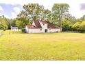 A large and well-maintained backyard features a level lawn and a distant view of the home's rear at 175 Heritage Farm Ln, Fayetteville, GA 30215