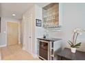 Hallway with bar area featuring wine cooler and glassware display at 3324 Peachtree Rd # 2717, Atlanta, GA 30326