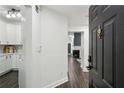 View of the kitchen, hallway, living and dining area with hardwood floors and neutral paint scheme at 63 Fulton Se St, Atlanta, GA 30312